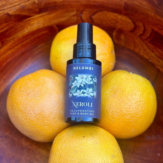 Nelumbi Neroli Face & Body Oil on bowl of oranges